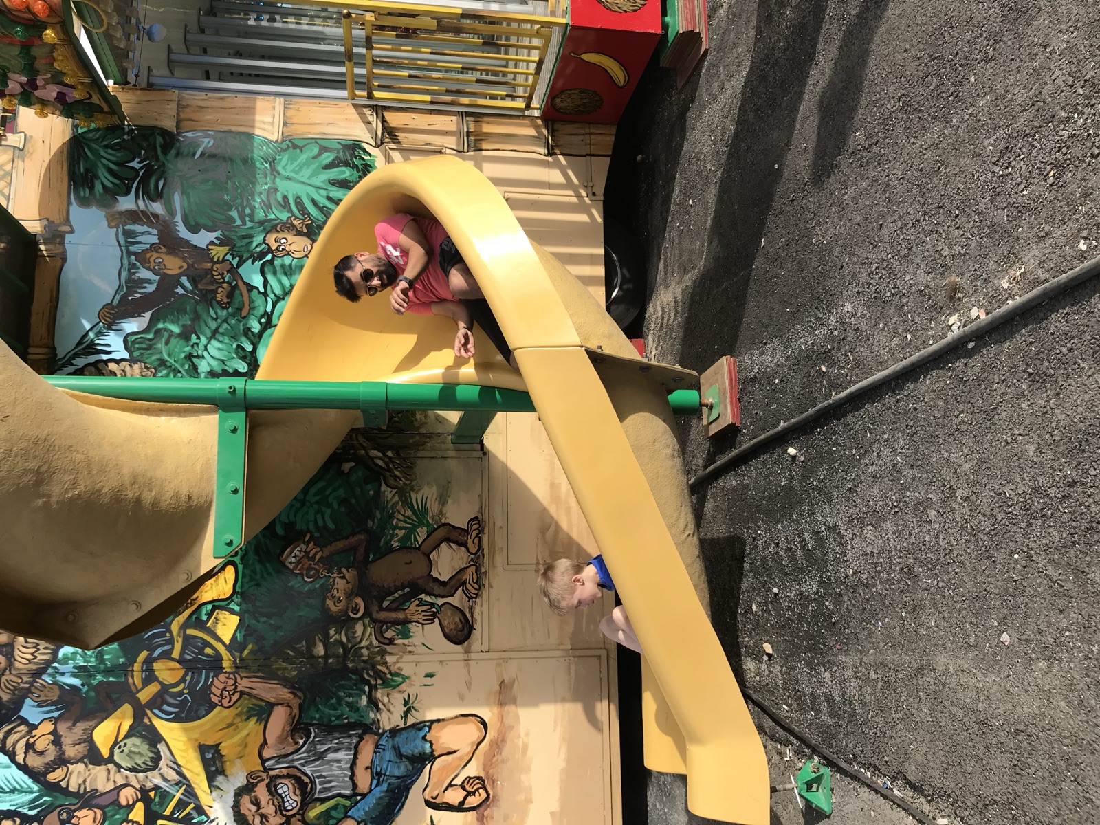 Sohail at the bottom of a carnival slide with one of the boys